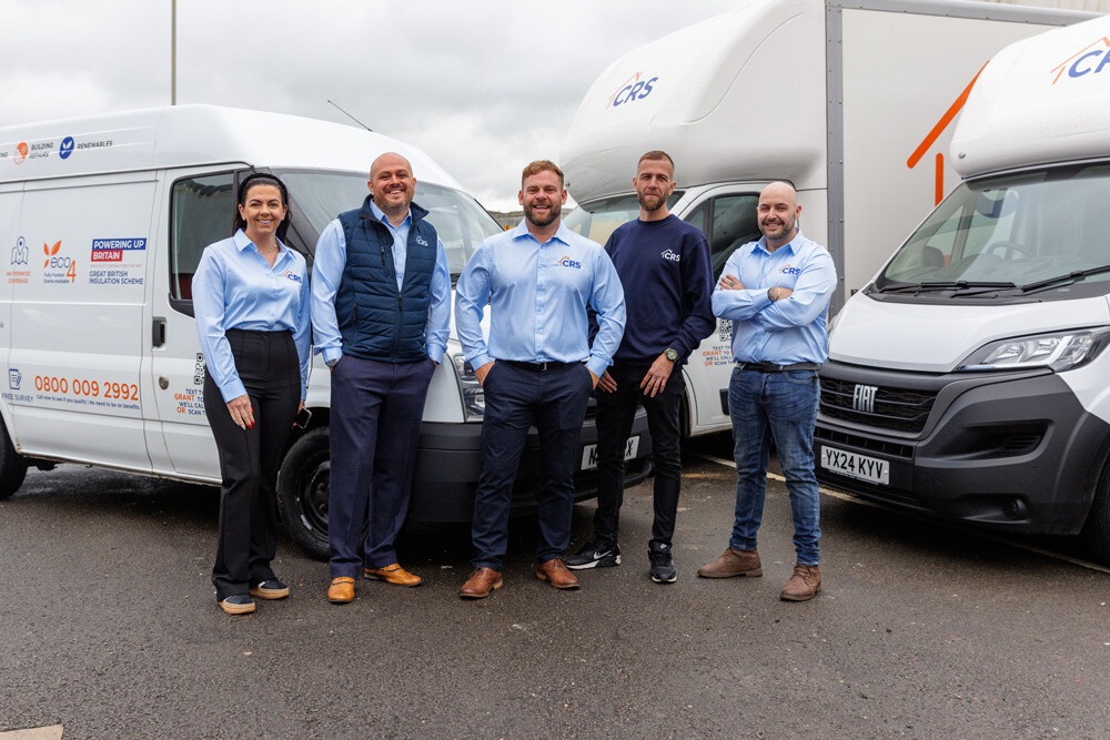 CRS Energy team in front of branded vans