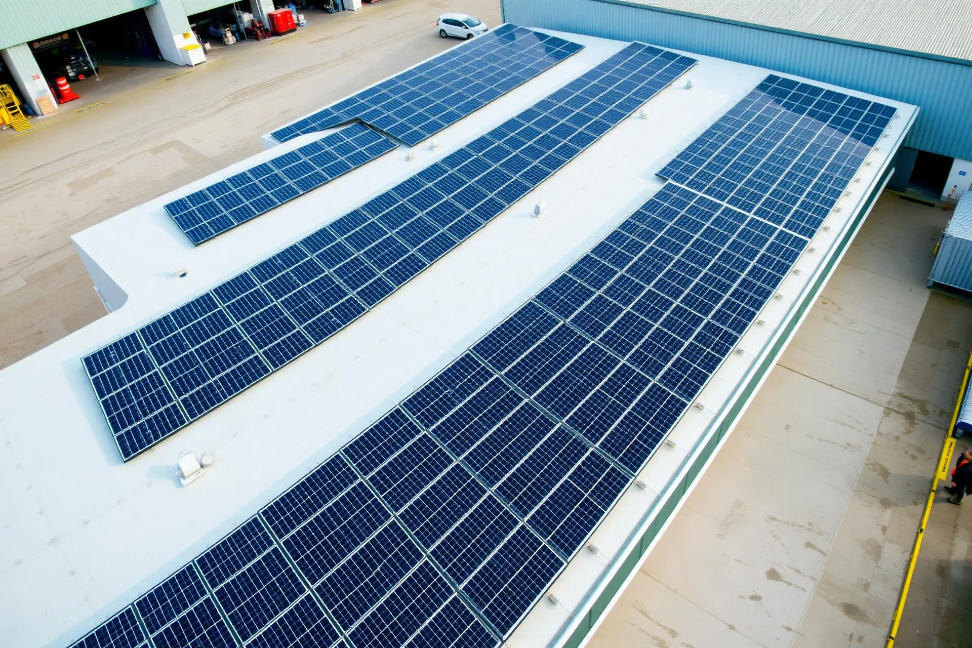 Aerial view of a commercial rooftop solar PV array on a UK industrial building